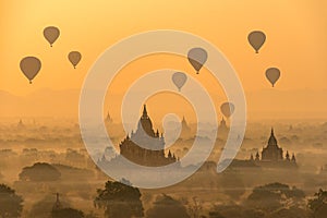 Hot air balloons float over pagodas field