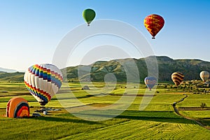 Hot air balloons fly over Cappadocia, Goreme, Cappadocia, Turkey.