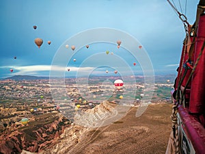 Hot air balloons flying over the Cappadocia landscape