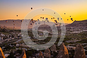 Hot air balloons flying over Cappadocia Turkey at sunrise golden hour