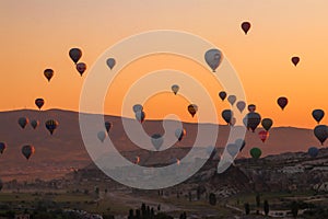 Hot air balloons flying over Cappadocia Turkey at sunrise golden hour