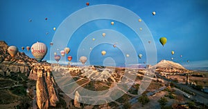 Hot air balloons flying over a mountain in Cappadocia, Turkey
