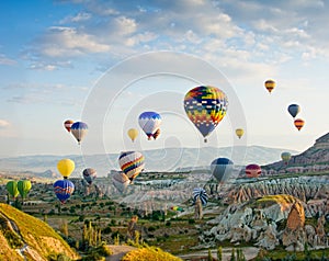 Hot air balloons flying over Red valley at Cappadocia, Turkey