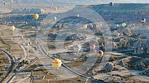 Hot air balloons flying over the valleys of Cappadocia, Turkey