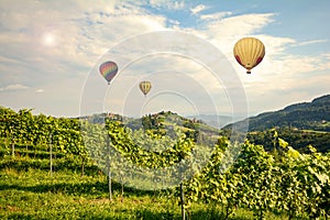 Hot air balloons flying over the vineyards along South Styrian Wine Road, Austria