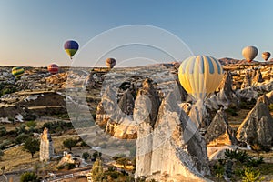 Hot air balloons flying at sunrise