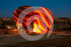 Hot air balloons are getting ready to fly at sunrise in Cappadocia Turkey