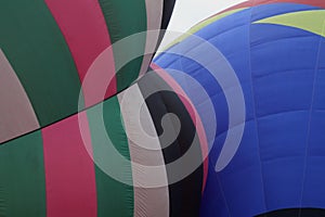 Hot air balloons inflate during a mass ascension