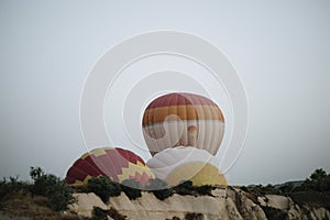 Hot air balloons landing in a mountain Cappadocia Goreme National Park Turkey