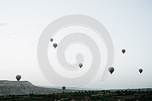 Hot air balloons landing in a mountain Cappadocia Goreme National Park Turkey