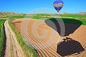 Hot air balloons landing in spring fields Cappadocia Turkey