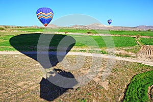 Hot air balloons landing in spring fields Cappadocia Turkey