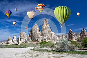 Hot air balloons over the cave town, Valley of Daggers, Cappadocia, Turkey