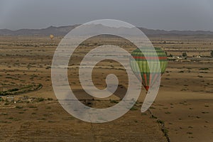 Hot air balloons over desert pastureland of Morocco