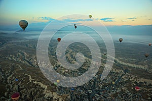 Hot air balloons over mountain landscape in Cappadocia, Goreme National Park, Turkey. Aerial view from air balloon