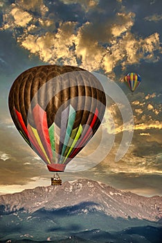 Hot Air Balloons before Pikes Peak Mountain under a cloudy morning sky