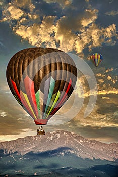 Hot Air Balloons before Pikes Peak Mountain under a cloudy morning sky photo