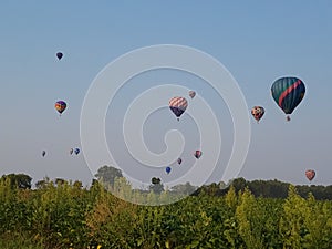 Hot air balloons racing across horizon