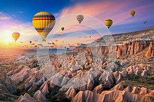 Hot air balloons and Red valley at sunset in Goreme, Cappadocia in Turkey. photo