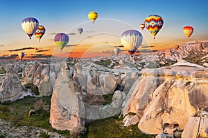 Hot air balloons at sunset over the cave town, Cappadocia