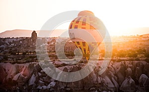 Hot air balloons between the texture of rocks in cappadoccia at sunrise