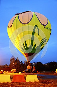 Hot air baloon starting to fly in the evening sky