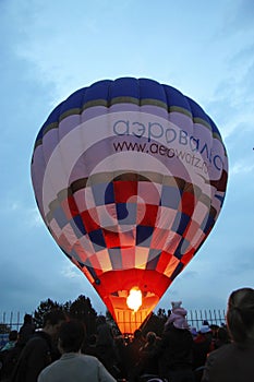 Hot air baloon starting to fly in the evening sky