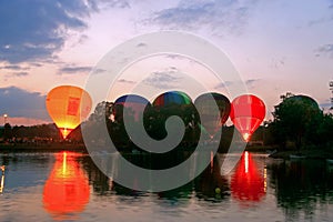 Hot air baloons startung to fly in the evening sky