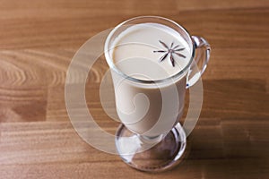 The hot alcoholic drink eggnog on wooden background