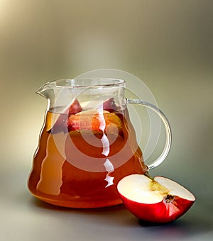 Hot apple tea in a glass teapot