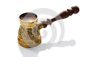 Hot arabica coffee in a brass jezve
