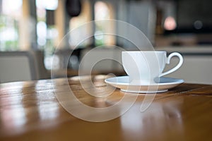 Hot art coffee cappuccino in a cup on wooden table background