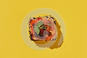 Hot baked suchi roll with salmon on yellow background