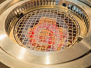 Hot barbecue fire with red glowing coals ready to grill.