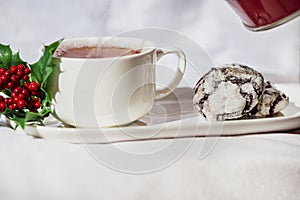 Hot beverage with delicious chocolate crinkle biscuits on a white background, isolated, close up