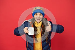 Hot beverage. Idea for warming. Happy girl hipster. Child warm knitwear. Green tea no sugar. Baby tea cup. Have warming