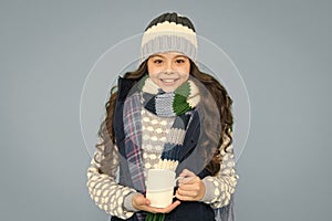 Hot beverage. Idea for warming. Happy girl hipster. Kid winter fashion. Child warm knitwear. Baby tea cup. Have warming