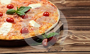 Hot big margarita pizza with mozzarella melting cheese bacon tomatoes