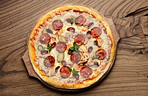 Hot big pepperoni pizza tasty pizza composition with melting cheese bacon tomatoes ham paprika