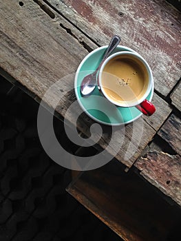 Hot black coffee cup on the old wooden table.