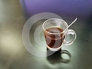 Hot black coffee cup on the table in black.