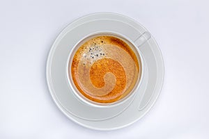 Hot black coffee with foam bubbles in white cup with white background, morning coffee concept.