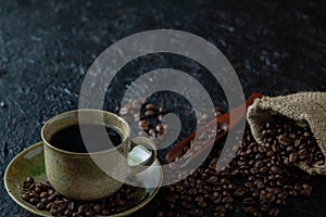 Hot black coffee for morning beverage menu in vintage brown ceramic cup with coffee beans roasted