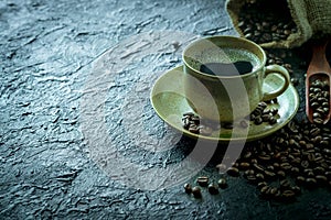 Hot black coffee for morning beverage menu in vintage brown ceramic cup with coffee beans roasted