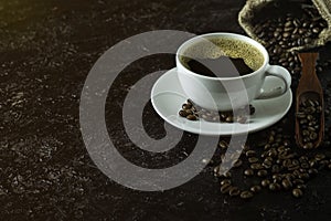 Hot black coffee for morning beverage menu in white ceramic cup with coffee beans roasted