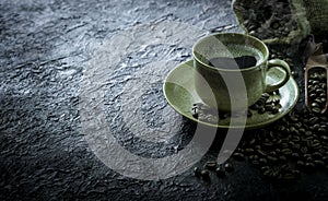 Hot black coffee with smoke for morning beverage menu in vintage brown ceramic cup with coffee beans roasted