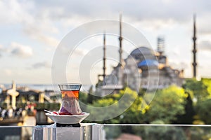 Hot black Turkish tea. Cups of Turkish tea with a saucer against the backdrop of the Hagia Sophia at dawn.