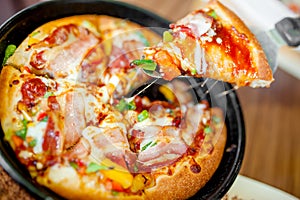 Hot cannibal slice of pizza with extra bacon, ham and vegetables