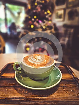 Hot cappuccino coffee in a drinking glass Placed on the table in a warm atmosphere. There is space for text