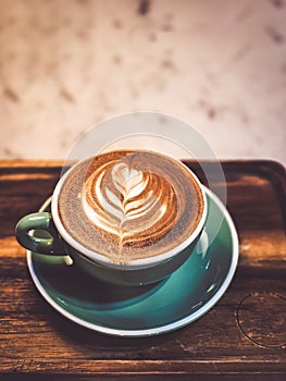 Hot cappuccino coffee in a drinking glass Placed on the table in a warm atmosphere. There is space for text